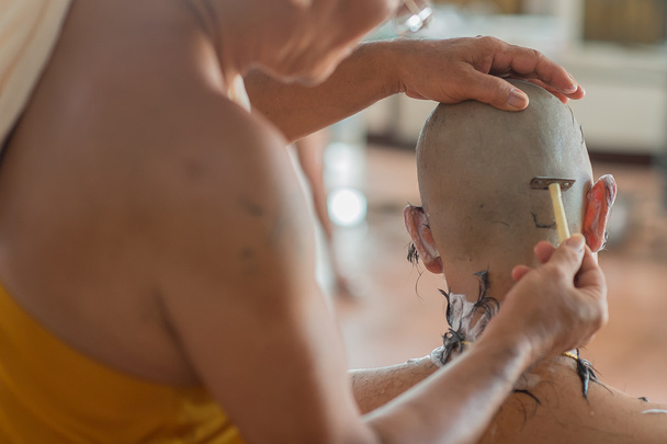 Buddhist monks shave their hair to be ordained a priest - Fotoğraf, Görsel