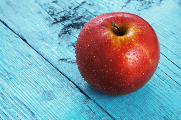 Red apple on a blue background - Photo, Image