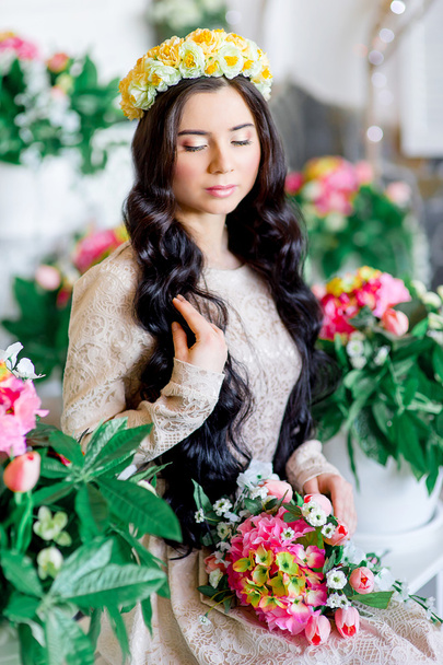 girl with black hair on the background of flowers - Fotografie, Obrázek