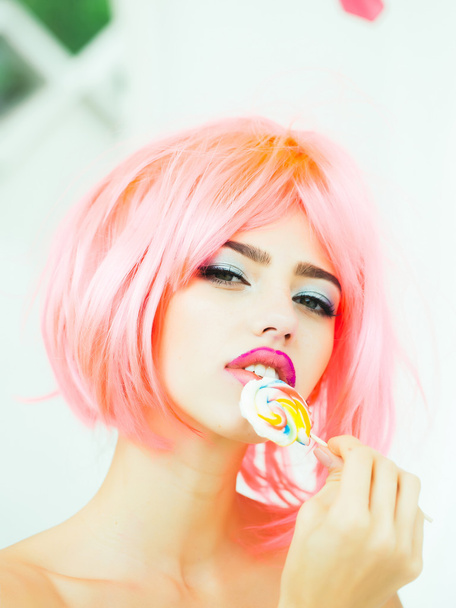 woman with orange hair lick lollipop - Foto, Imagem