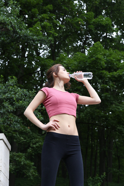 Young woman drinking water. - Zdjęcie, obraz