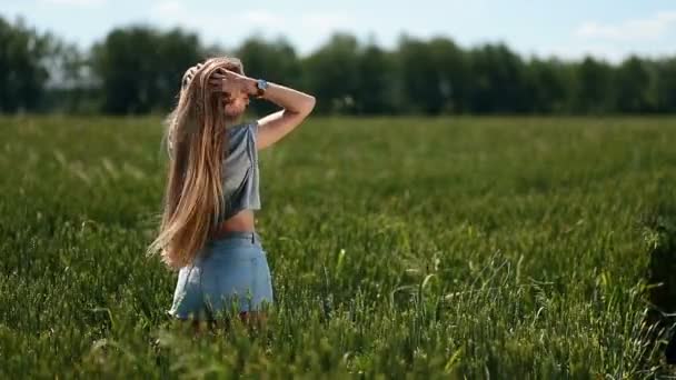 Beautiful woman playing with hair in the wind - Footage, Video