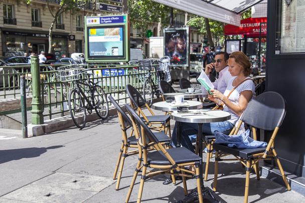 PARIS, FRANCE, on JULY 12, 2016. Typical city street. People rest in summer cafe on the sidewalk. - Photo, Image