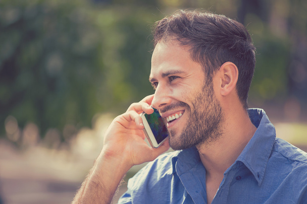 handsome happy smiling urban professional man using talking on smart phone - Fotó, kép
