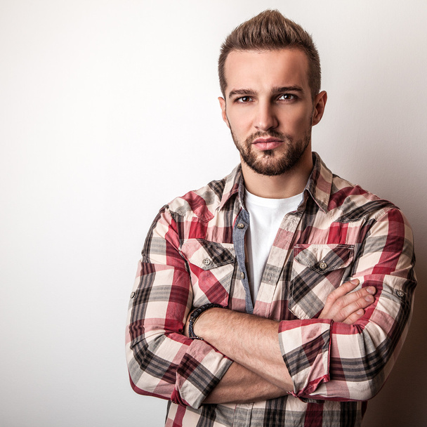 Young handsome man in colorful shirt pose in studio - Foto, Imagem