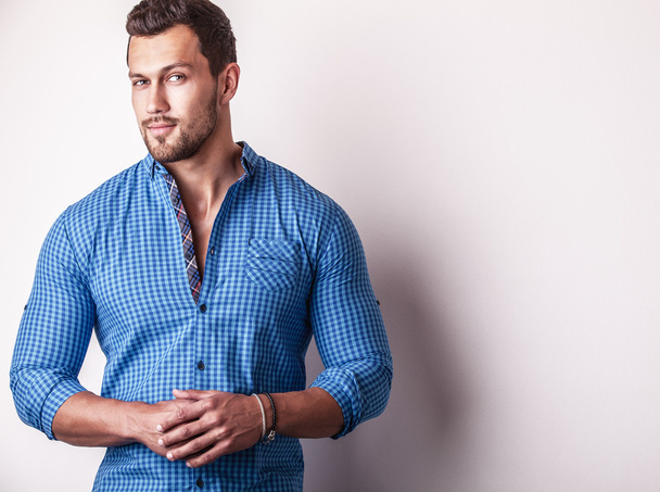 Elegant young handsome man in stylish blue shirt. Studio fashion portrait - Photo, image