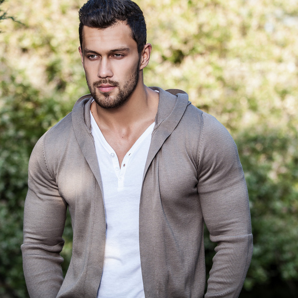 Sporty handsome man in casual clothes poses outdoor - Φωτογραφία, εικόνα