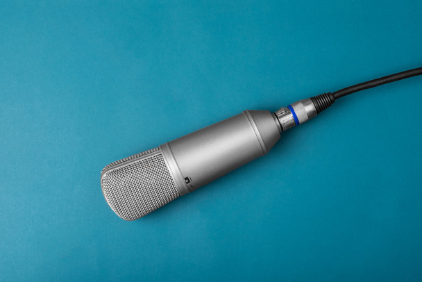 Isolated studio microphone on a blue background - Photo, image