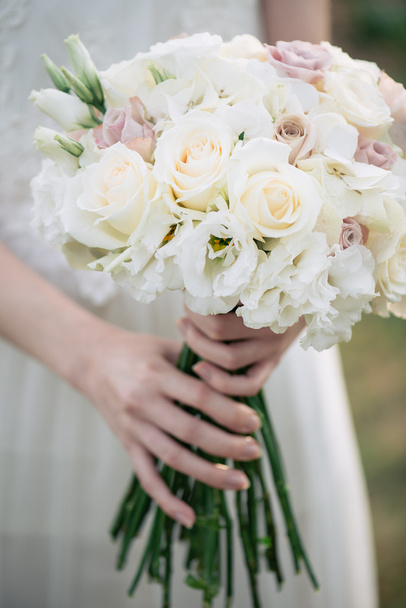 Bride holding wedding bouquet  - Zdjęcie, obraz