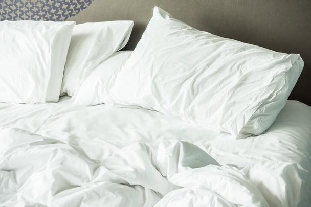rumpled bed with white messy pillow  - Fotoğraf, Görsel