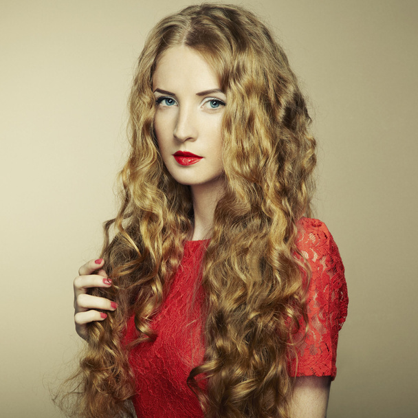 Portrait of beautiful woman with red hair in red dress - Foto, afbeelding