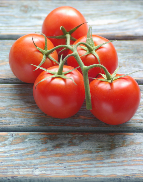 Tomatoes on rustic wooden background - Foto, afbeelding