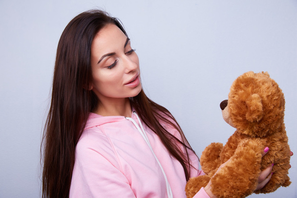 brunette playing with teddy bear - Zdjęcie, obraz