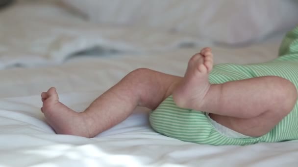 Newborn baby lying on a bed - Filmati, video