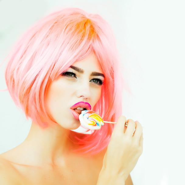 woman with orange hair lick lollipop - Foto, Imagen
