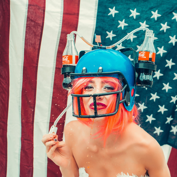 woman in american football drink helmet - Photo, Image
