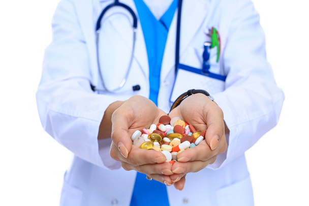 Doctor holding heap of drugs in a hand - Фото, зображення