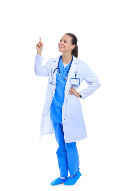 A portrait of a female doctor pointing isolated on white background - Фото, изображение