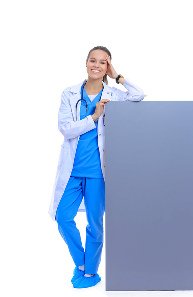 A female doctor with a blank billboard. - Foto, Imagen