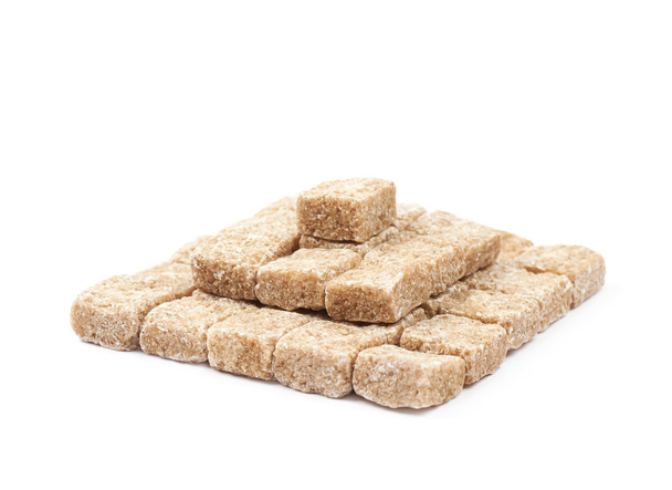Pile of brown sugar cubes isolated - Foto, imagen