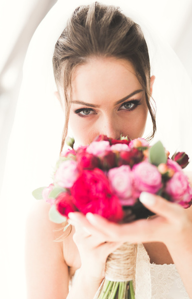 Beautiful bride with wedding bouquet posing in old city - Photo, Image