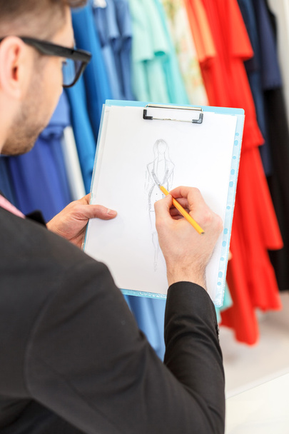 Skillful male tailor creating new dress - Foto, immagini