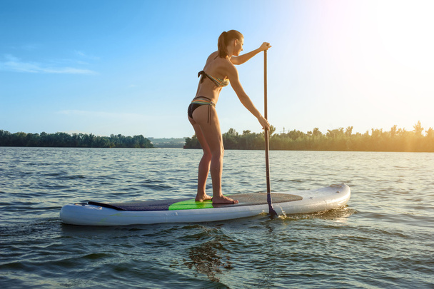 SUP Stand up paddle board woman paddle boarding12 - Foto, Imagen