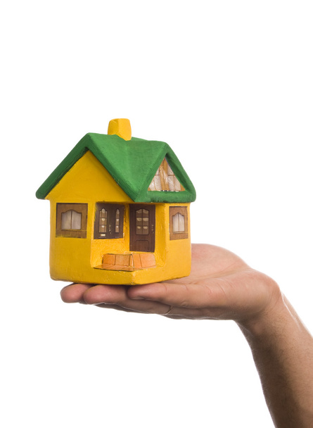 Маленький модельний будинок на чоловічій руці
 - Фото, зображення