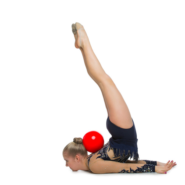 Beautiful gymnast girl with red ball - Фото, изображение