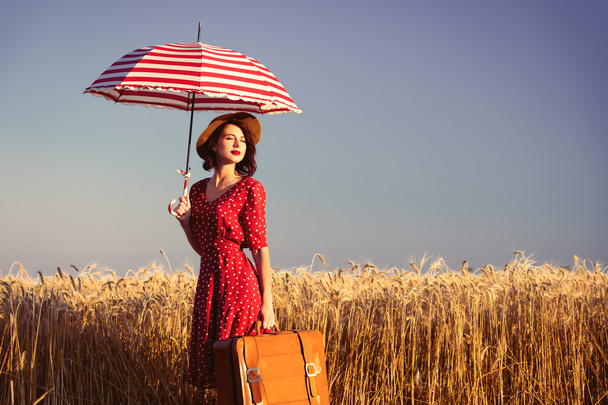 young woman with umbrella and suitcase - Photo, Image
