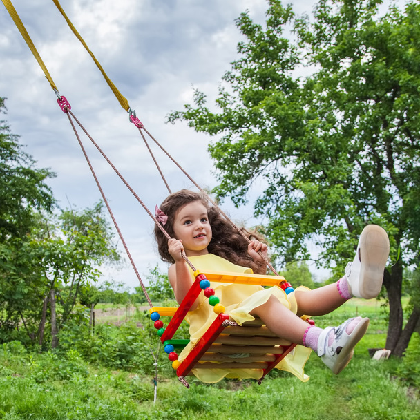 Baby girl in swing outdoors - Photo, Image