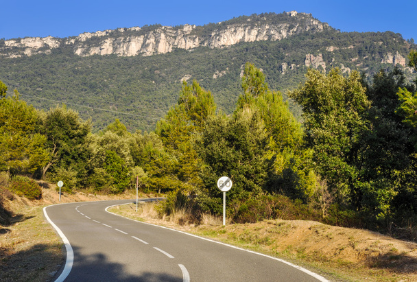 Typische bergweg in Spanje met gekruiste 60 km/h maximumsnelheid. - Foto, afbeelding