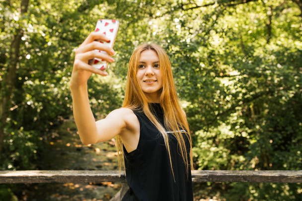 Blonde girl taking a selfie - 写真・画像