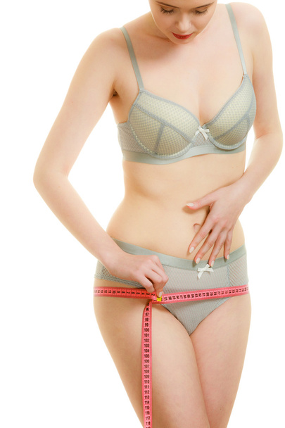 Woman in lingerie measuring her hips - Fotoğraf, Görsel