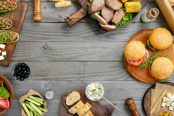 grilled burgers, steaks, stuffed zucchini, vegetables and sauces - Fotoğraf, Görsel