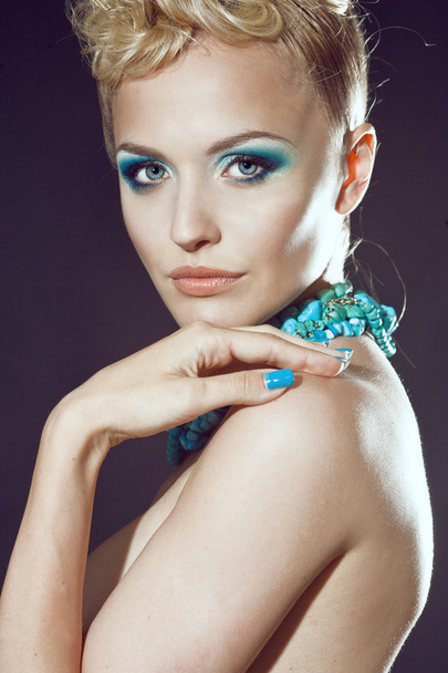 Beautiful sexy young woman with turquoise makeup and accessories - Valokuva, kuva