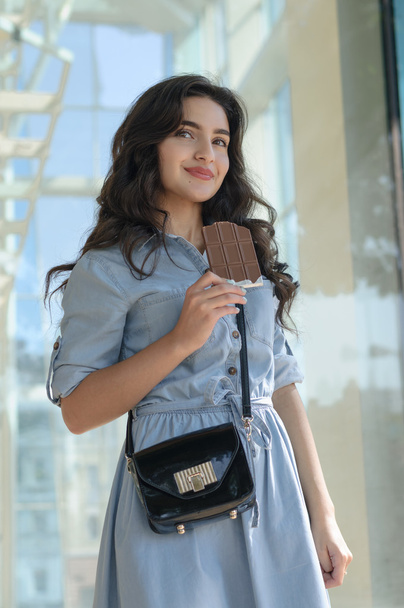 Woman holding a bar of chocolate.  - Photo, Image