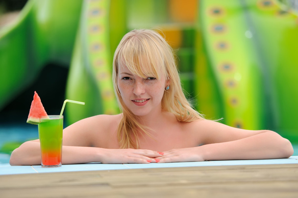 Women drinking cocktail in pool - Photo, Image