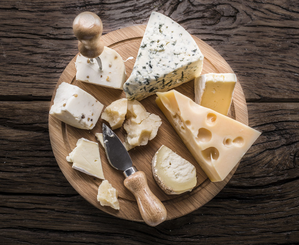 Variety of cheeses. Vintage stiles. - Фото, изображение
