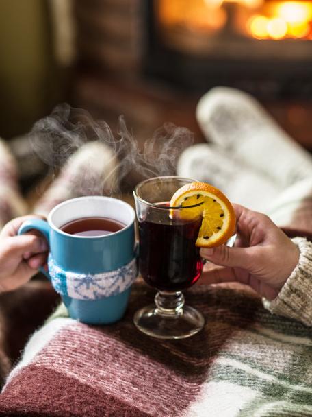Warming and relaxing near fireplace with a cup of hot drink. - Foto, immagini