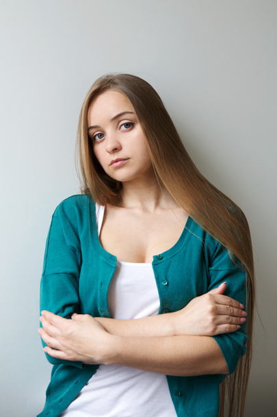 Portrait of the beautiful sad young woman with long hair - Фото, зображення