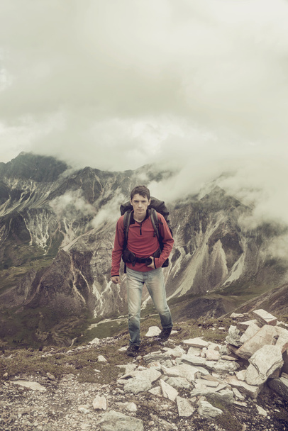 man climbs a mountain at the beautiful view - 写真・画像