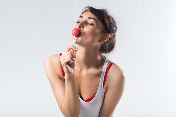 Young brunette model with lollipop  - Photo, Image