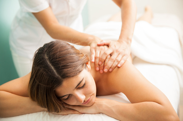 brunette getting a relaxing massage  - Фото, зображення