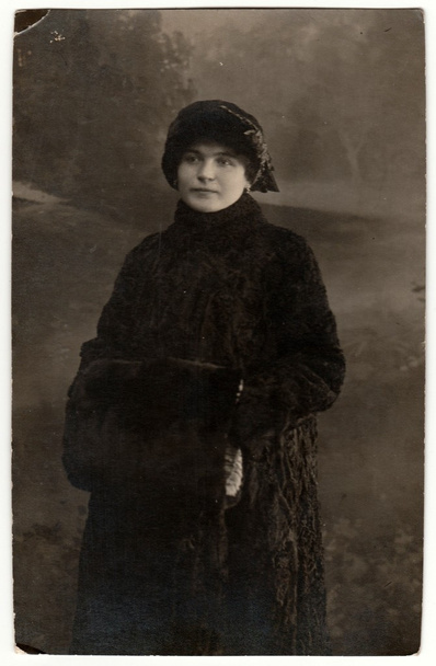  Vintage photo shows woman wears fur coat and fur muff. Retro black & white studio photography. - Photo, Image