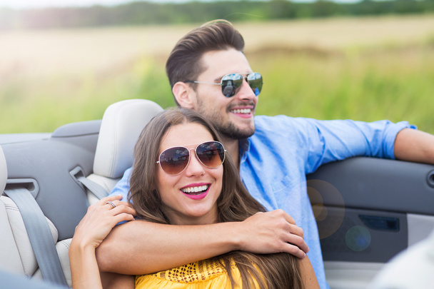 Couple enjoying a drive in a convertible - Photo, image