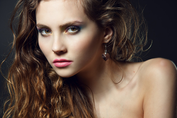 Face of a beautiful young woman with bright makeup - Fotó, kép