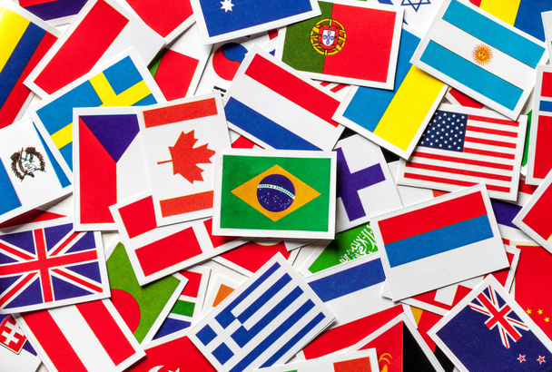 National flags of the different countries of the world in a scattered heap. Brazilian flag in the center. - Photo, Image