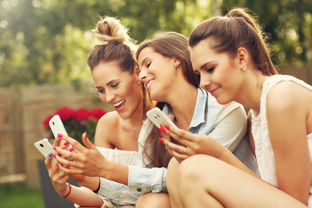 Grupo feliz de amigos com smartphones
 - Foto, Imagem
