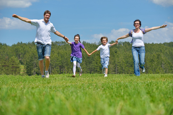 Happy young family have fun outdoors - Фото, зображення